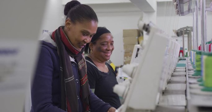 Group of mixed race women working in factory