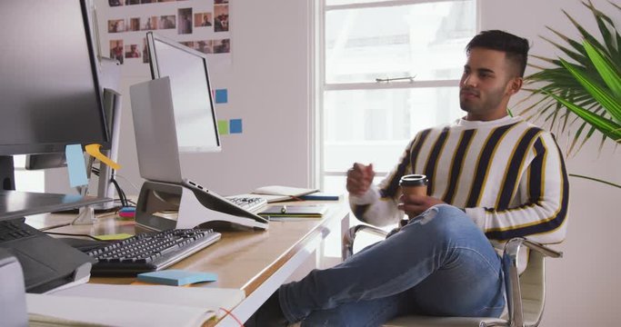 Mixed race man working in creative office