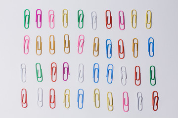 multicolored paper clips on a white background