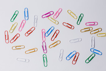multicolored paper clips on a white background