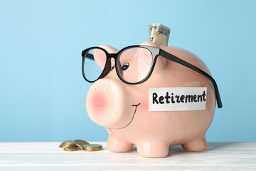 Piggy bank and money against blue background, close up