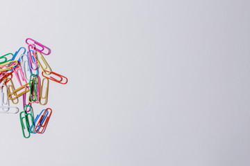 multicolored paper clips on a white background