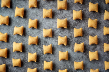 Corn chips with spices on a concrete background