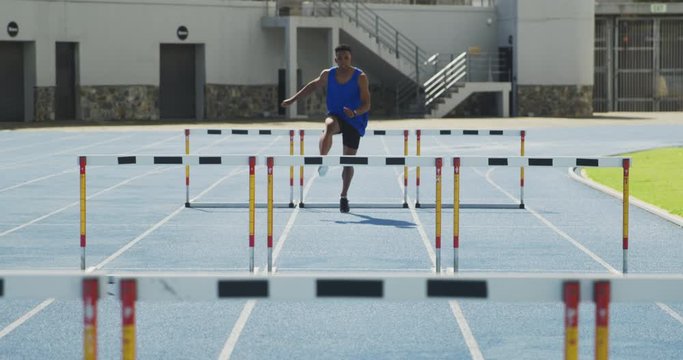 Front view of african american athlete doing hurdling