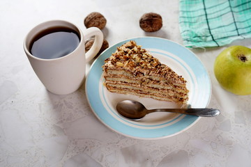 Walnut cake and a Cup of tea on a light table