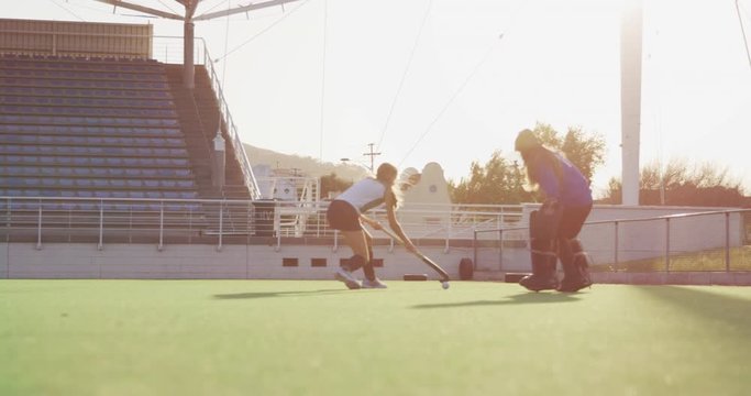 Female hockey players playing on the field