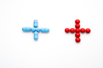 medicine sign made from red and blue pills isolatad on white background , medicine concept