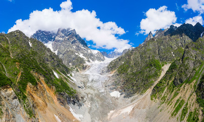 Caucasus Mountains on the border of Russia and Georgia. Chalaat Pass and Very beautiful view of the Chalaadi Glacier, Mount Ushba and Mestiachala river with background of clear blue sky.