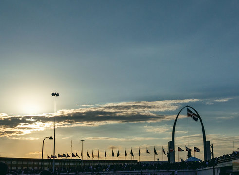 The sunset with people gathered in Dominican flag monument with the flag in the background