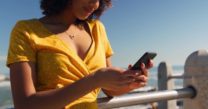 Woman using phone at beach