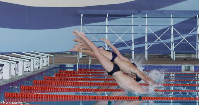 Swimmers diving into the pool