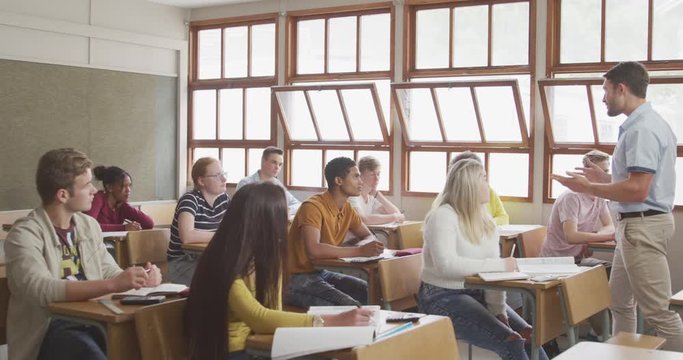Teacher speaking to students in high school class