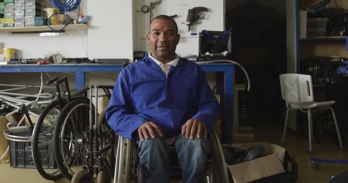 Disabled man with wheelchair looking at the camera