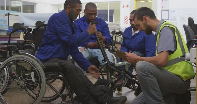 Workers with disabled man working