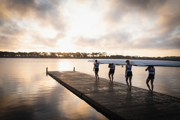 Female rowing team training on a river