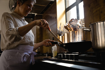 Caucasian chef cooking vegetables