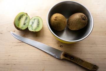 kiwi and knife on cutting board