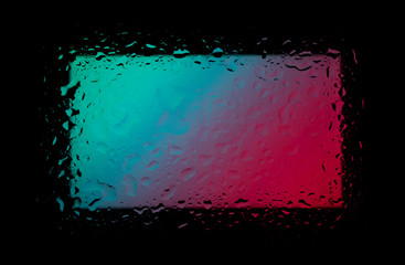 Colored abstract wallpaper on a black background with raindrops on glass
