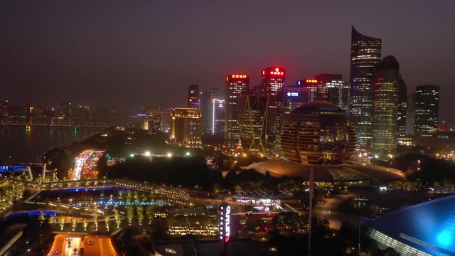 sunset night illumination hangzhou city downtown riverside traffic bay aerial panorama 4k china