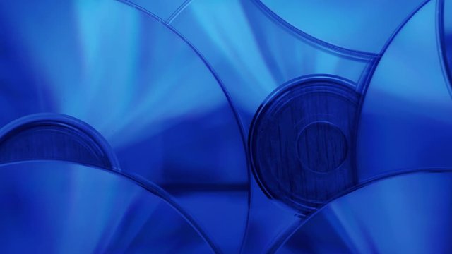 Hovering over pile of cd-rom disks illuminated by blue light.