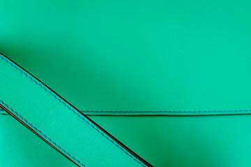Detail of genuine grainy leather of light mint green color, leather handbag. Texture and...