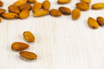 Almonds on a white wooden surface