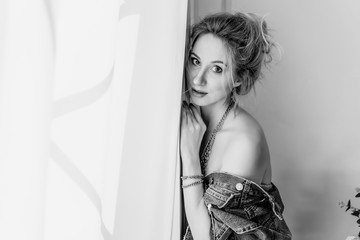 a blonde girl in denim shirt. black-white 