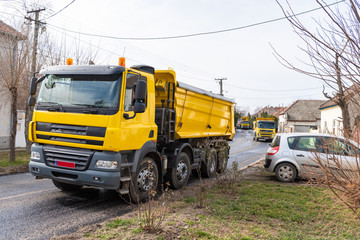 Workers with machines and rollers pave the new road