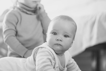 a child crawls on the floor in an apartment