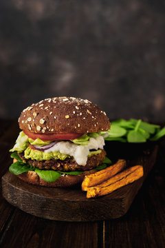 Vertical shot of vegan lentils burger and sweet potato