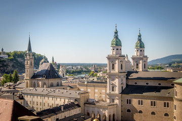 Obraz premium The Franciscan Church, Salzburg Cathedral and Stift St. Peter Salzburg in Salzburg over the banks of Salzach river as seen from Fortress Hohensalzburg