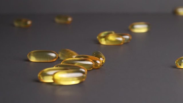 Omega-3 fish oil gel cap pills containing fatty acids, eicosapentaenoic acid and docosahexaenoic acid, precursors of certain eicosanoids