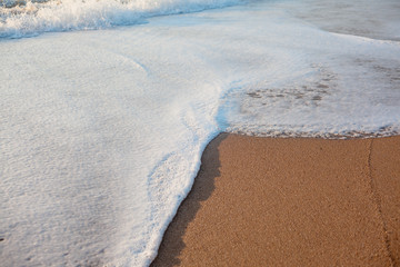 The wave splash with foam on shoreline