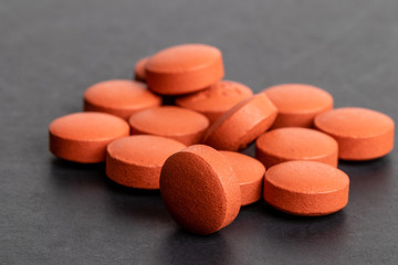 Ibuprofen tablets macro shot on black studio background NSAID or nonsteroidal anti-inflammatory drug illustrative pills medical or pharmaceutical copy space