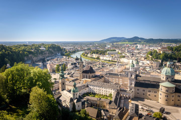 Fototapeta na wymiar The Franciscan Church, Salzburg Cathedral and Stift St. Peter Salzburg in Salzburg over the banks of Salzach river as seen from Fortress Hohensalzburg