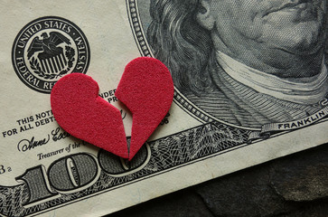 Cracked heart on money