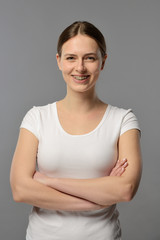 Obraz premium portrait of a young girl with braces in a white T-shirt on a gray background