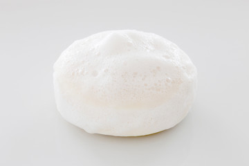Fototapeta na wymiar closeup white soap with foam on white background