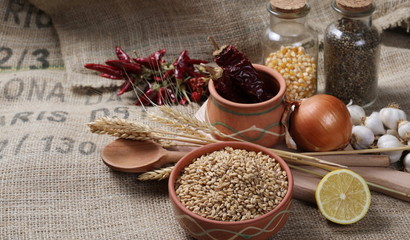 Wheat ears, with grain in clay pot  background and texture