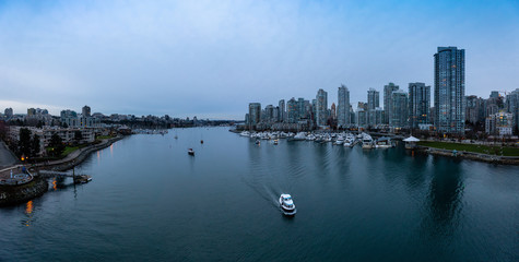 Downtown Vancouver, British Columbia, Canada. Beautiful Aerial Panoramic View of Modern City Buildings in False Creek during a colorful blue hour Sunset. Panorama