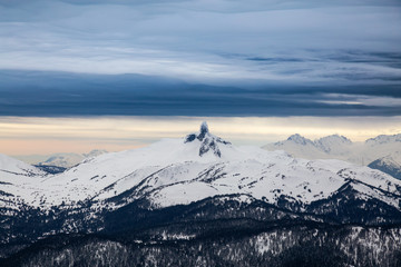 Fototapeta na wymiar Beautiful View of Black Tusk during a winter evening before cloudy sunset. Aerial Canadian Mountain Landscape. Taken from Whistler, British Columbia, Canada.