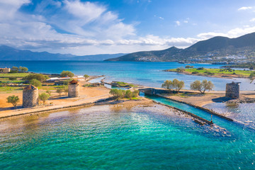 The famous canal of Elounda with the ruins of the old bridge,Crete, Greece. © gatsi