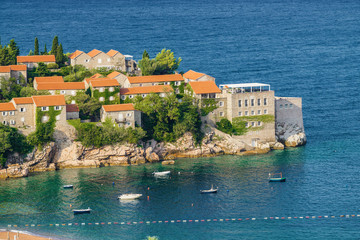 Sunny morning view of Sveti Stefan Island near city of Budva, Montenegro.