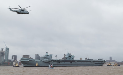 Merlin overflies HMS Prince of Wales down the Liverpool waterfront