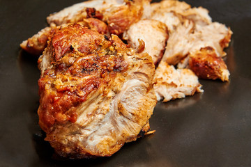 baked meat cut into pieces close up photo