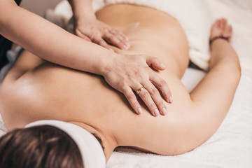 Fototapeta na wymiar Relaxing back massage in a beauty salon - smooth toned skin