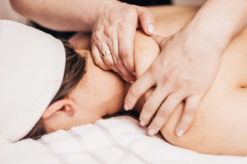 Stress relief in the massage parlor - relaxing massage of the trapezius muscle and shoulders - obrazy, fototapety, plakaty
