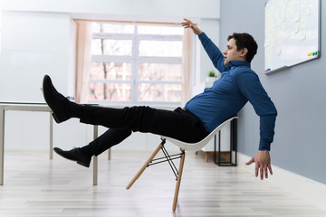 Man Falling On Chair In Office