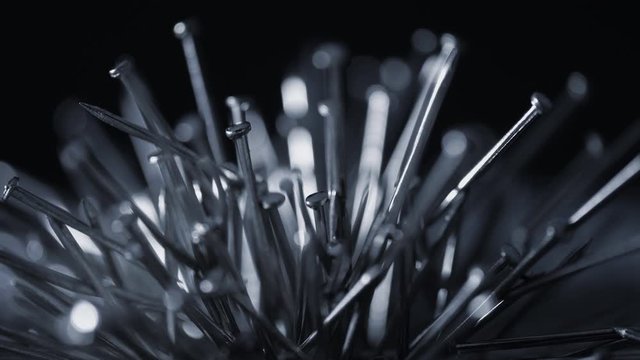 Metal nails under the influence of a magnetic field. Abstract background.