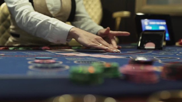 Dealer hands out cards at the gaming table